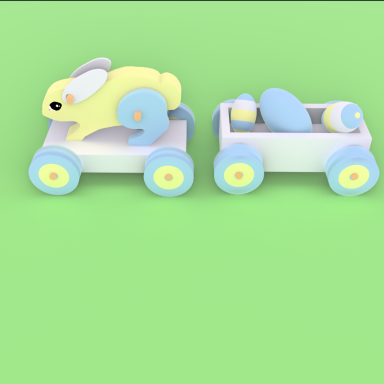 Initial Blender 3D Rabbit Yellow wooden rabbit on a pink trolley with a trailer carrying Easter Eggs